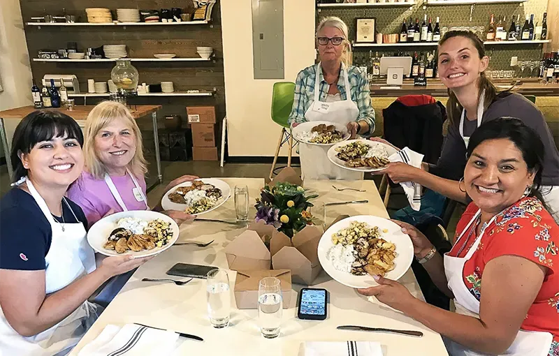 Clockwise from left: Diana Romero Campbell P’21, Anna Dyste ’08, Kathryn Dunn ’75, Susan Greene ’68, and Sofia Campbell ’21 enjoying a cooking class Meredith Badler ’08 and the Smith Club of Colorado and Wyoming organized.